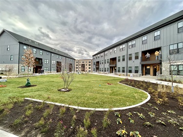 Photo of Golden Hill Apartments with lawn and landscaping in the foreground.