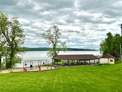 green lawn overlooking river at park