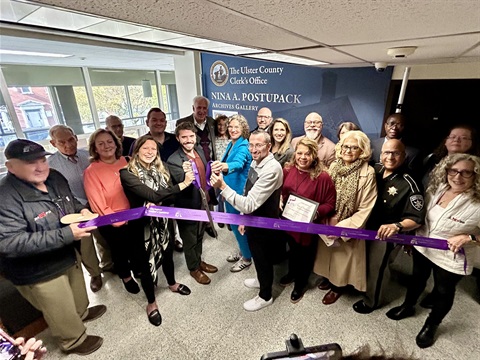 Crowd gathers to cut the ribbon on the newly dedicated Nina Postupack Archives Gallery