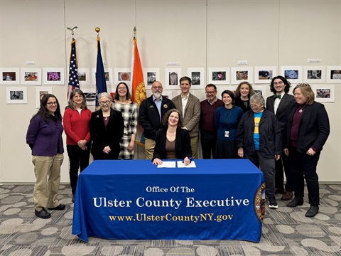 County Executive Metzger signing Executive Order 3 of 2026, affirming the County's commitment to fighting climate change