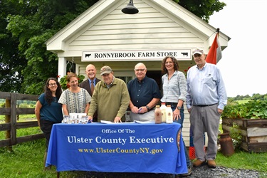 Group photo in front of Ronnybrook Farm Store: Deputy County Executive Amanda LaValle, Interim Director of Economic Development Leslie Wellington, UCEDA member Ward Todd, Ronnybrook owner Rick Osofsky, UCEDA Vice Chair Brian Cahill, County Executive Jen Metzger, and Ronnybrook business partner John LeSauvage.