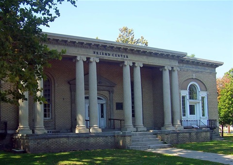 Photo of the Hunt Memorial Center in Ellenville, a beige brick building with columns and a sign reading 